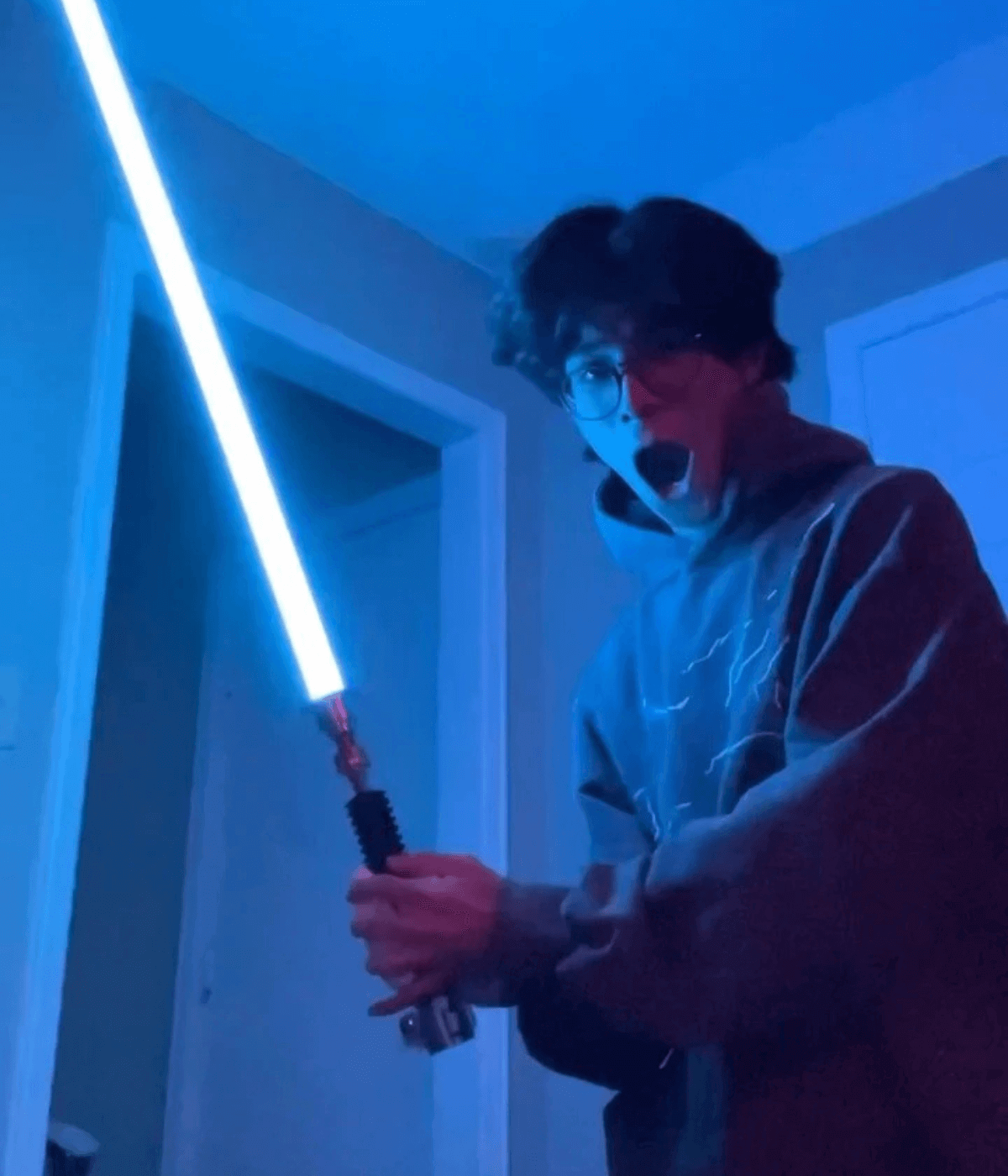 NSABERS customer holding an illuminated lightsaber